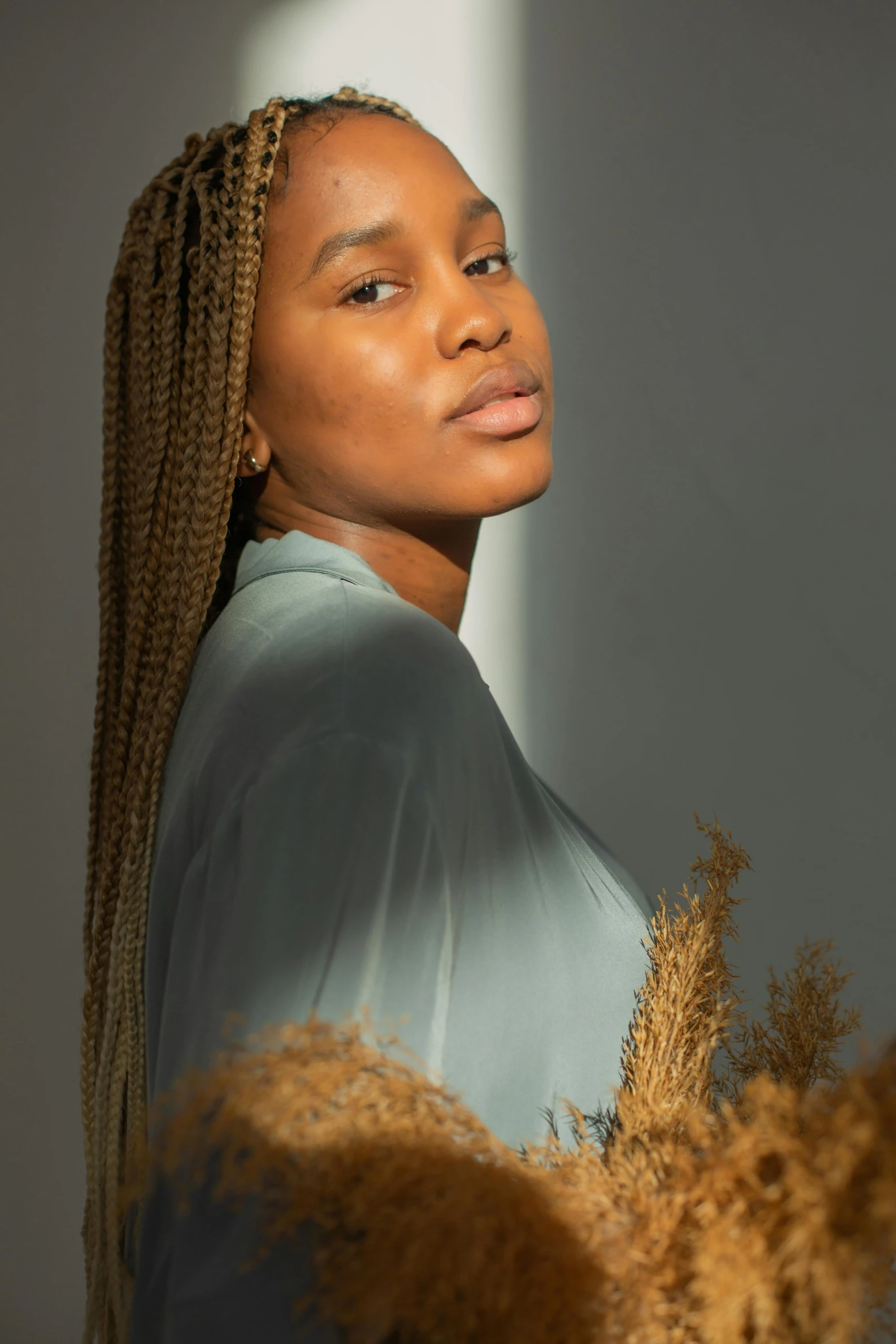 a close up of a young woman with large ids on a grey background