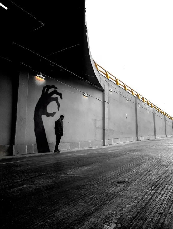 a silhouette is seen of a man standing on the side of a building