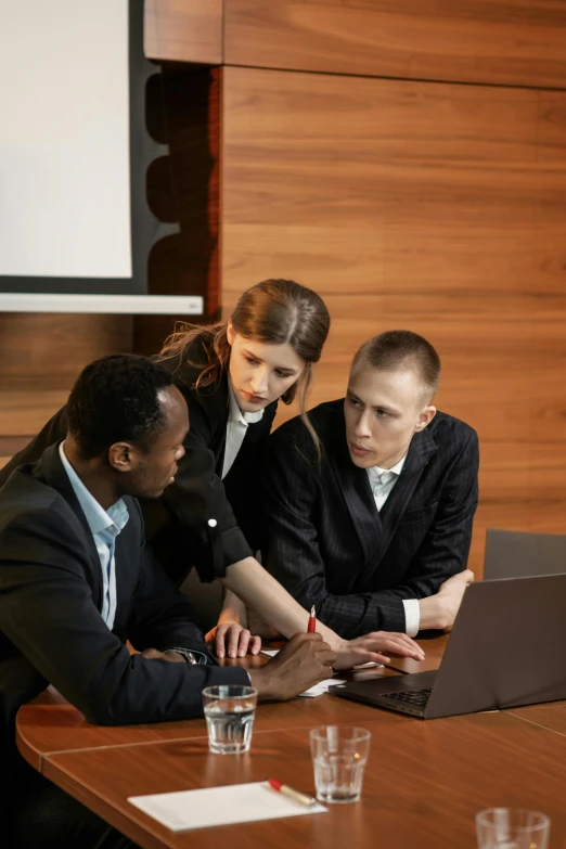 a couple of people that are sitting in front of a laptop