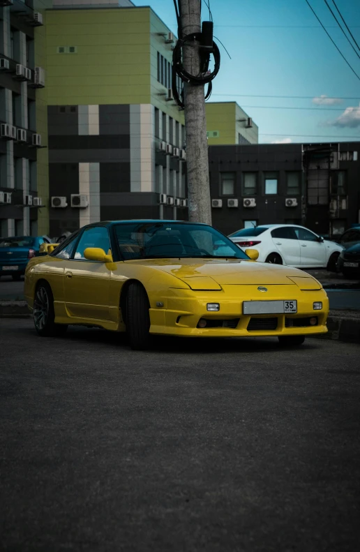 a car parked in the middle of a street near buildings