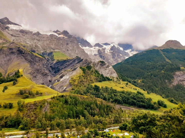 the mountain tops are covered in snow and green