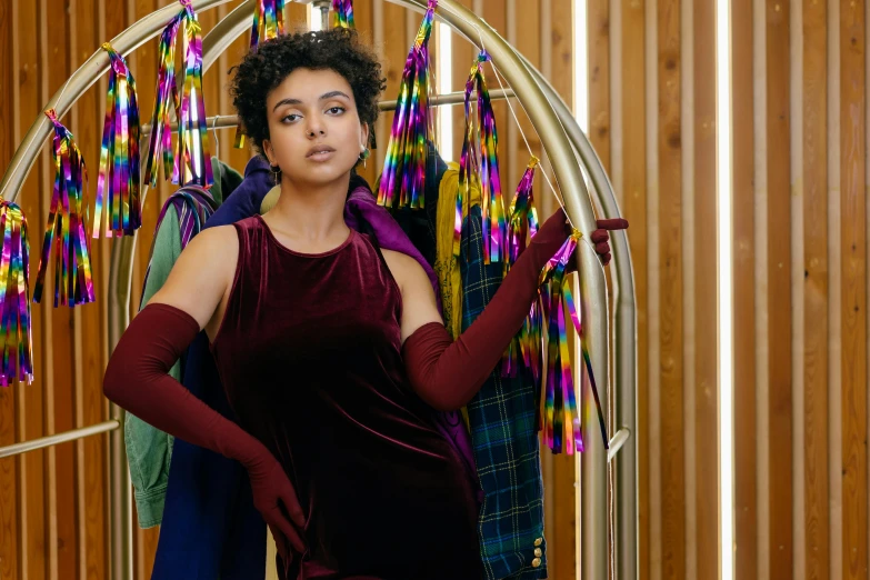 a woman holding onto a purple dress in a mirror