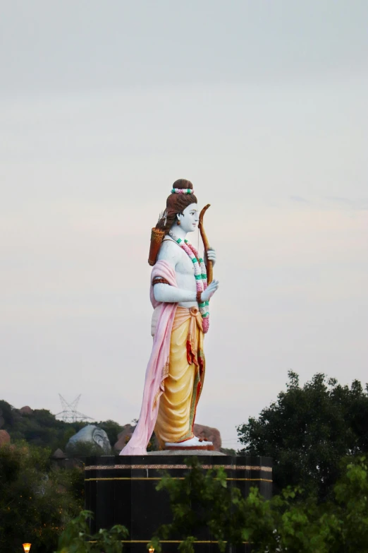 a statue of hindu god that is standing with an instrument