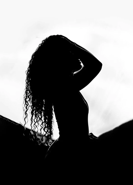 black and white po of a woman with long curly hair