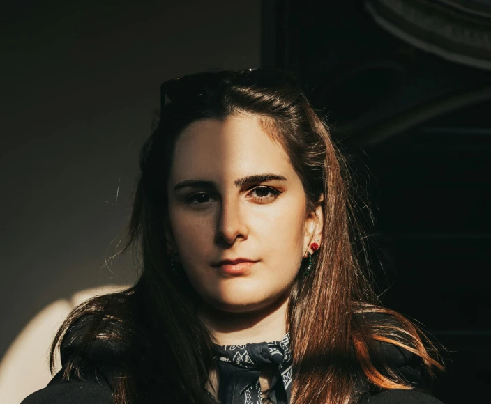 a young woman posing for the camera wearing an old school tie