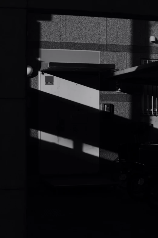 shadows on the wall of a building and a toilet