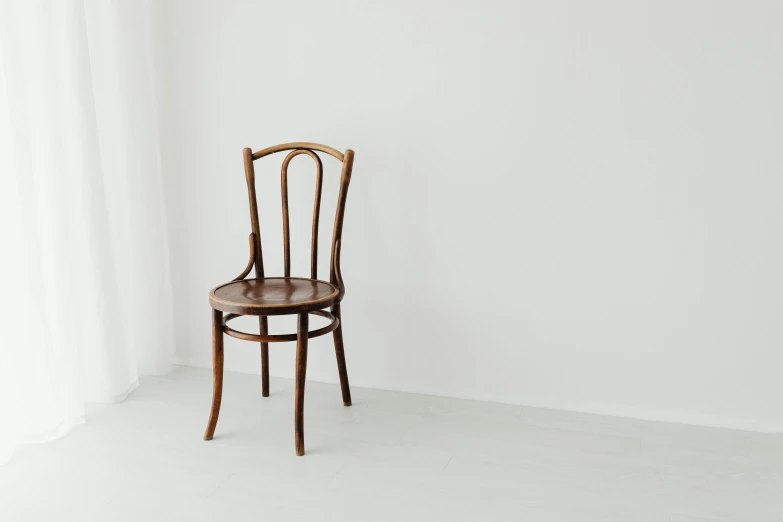 the chair is against a white wall and has no footrests