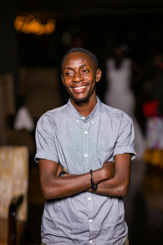 a smiling man with his arms crossed