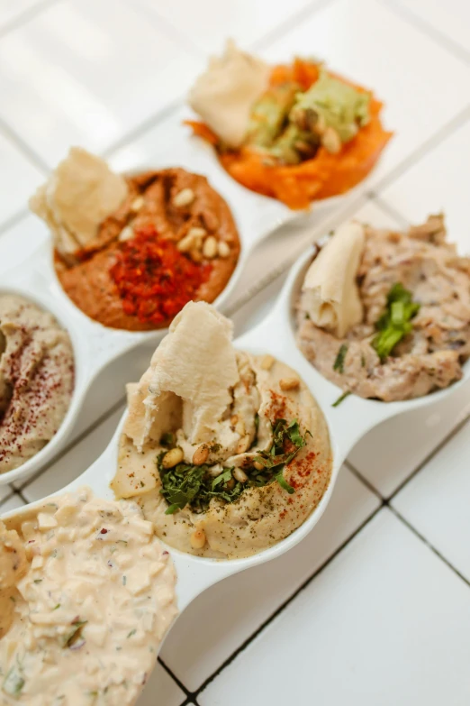 the seven different kinds of snacks sit on a serving tray