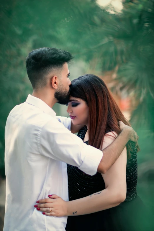 man in white shirt hugging lady in black dress