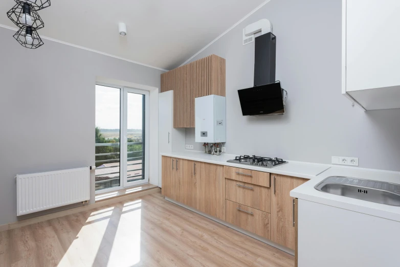 a kitchen with a sink, stove top and refrigerator