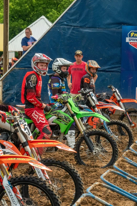 a group of dirt bikes sitting on top of dirt