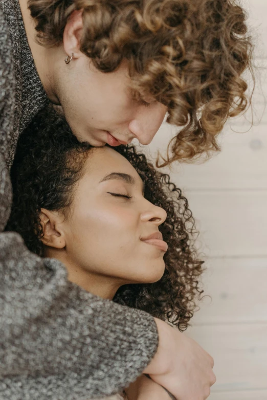 a young couple emcing each other in close proximity