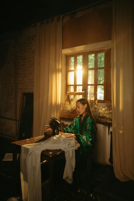 a woman sitting in front of a sewing machine