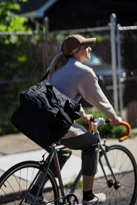 a woman riding a bicycle down the road