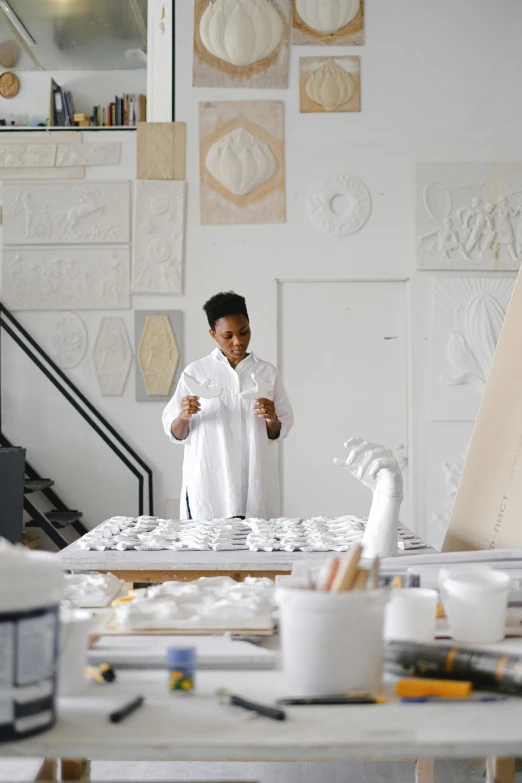 a woman standing in front of a white desk