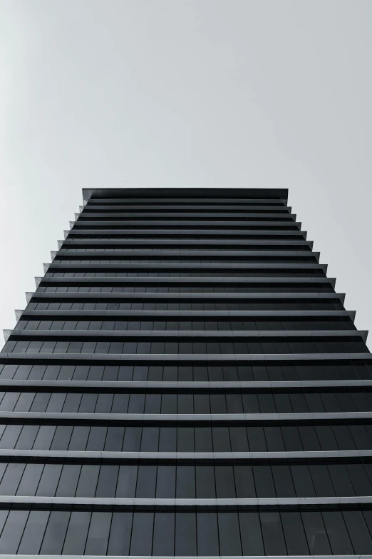 a black building is facing upward in the sky