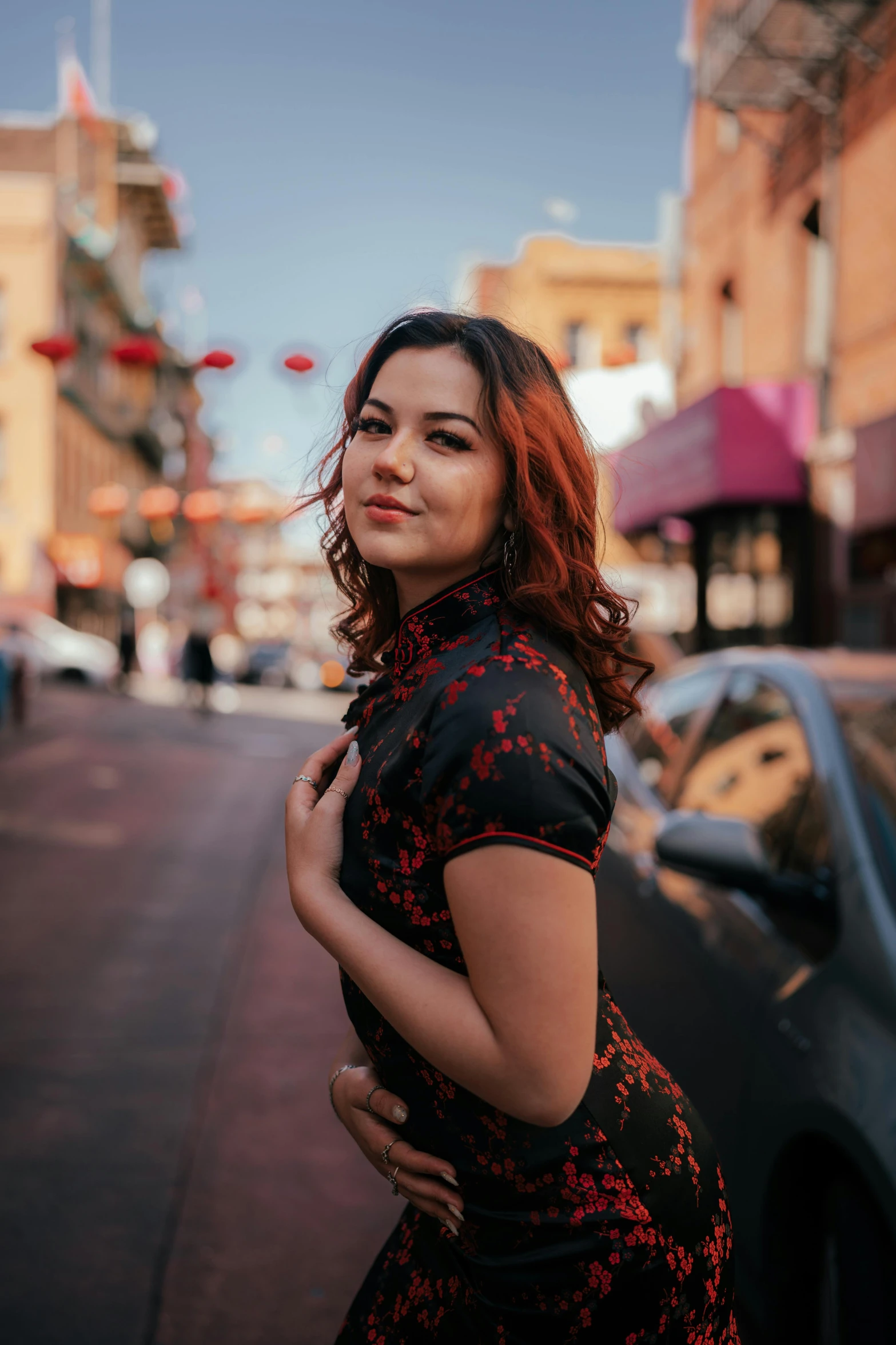 a pregnant woman standing on the side of a street