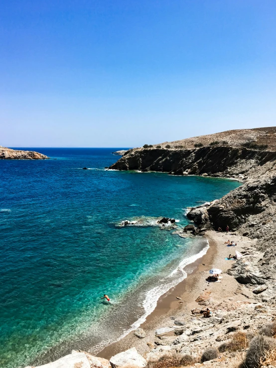 the water is very clear, with many people swimming