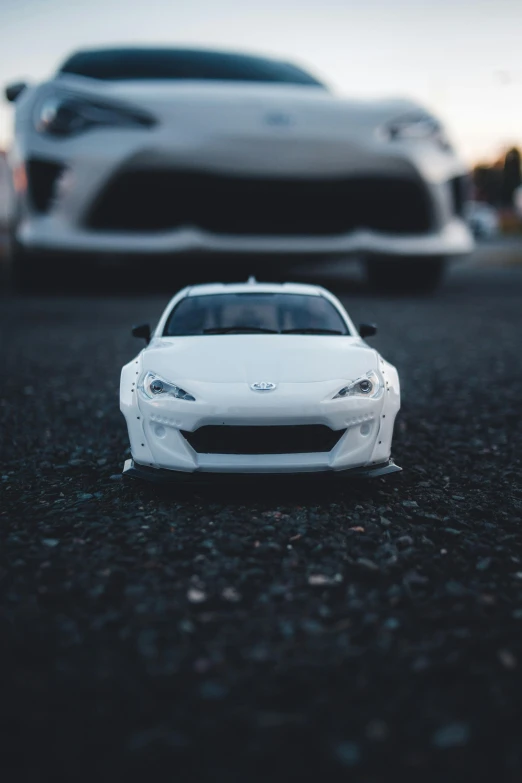 two white toys are lined up on the road