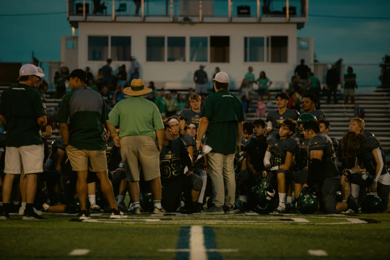 some football players on the sidelines during a game