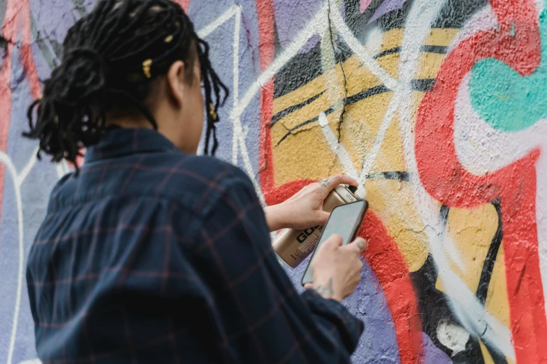 a woman with dread locks using a cell phone