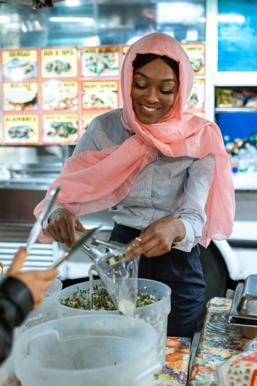 a woman is making some food in a kitchen