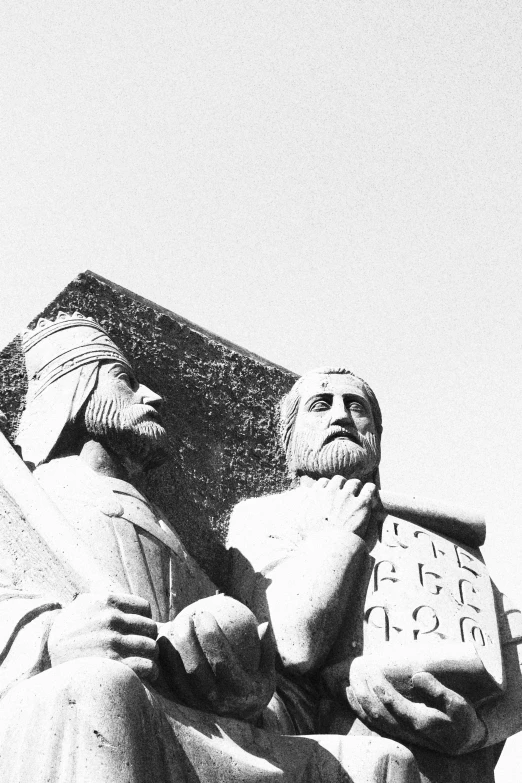 the head and torso of jesus in front of a stone statue