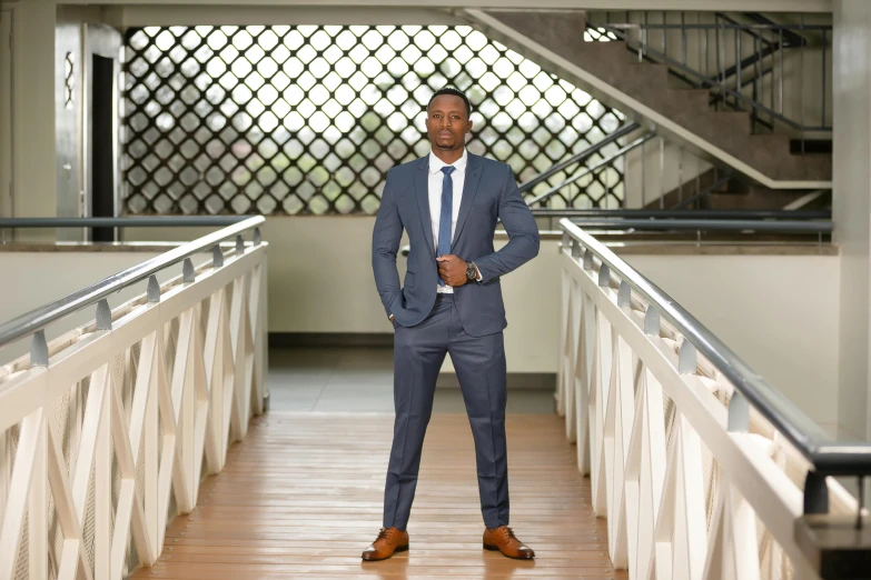 a man wearing a suit standing in a hallway