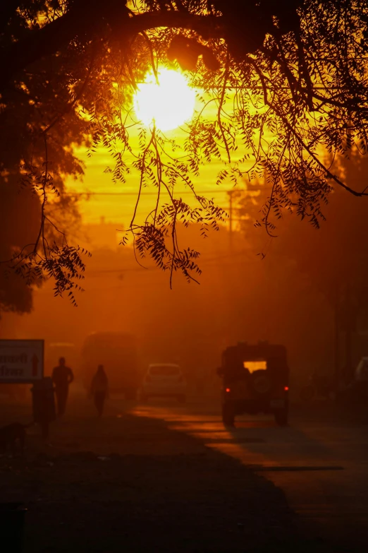 a misty picture with a few cars driving down a road