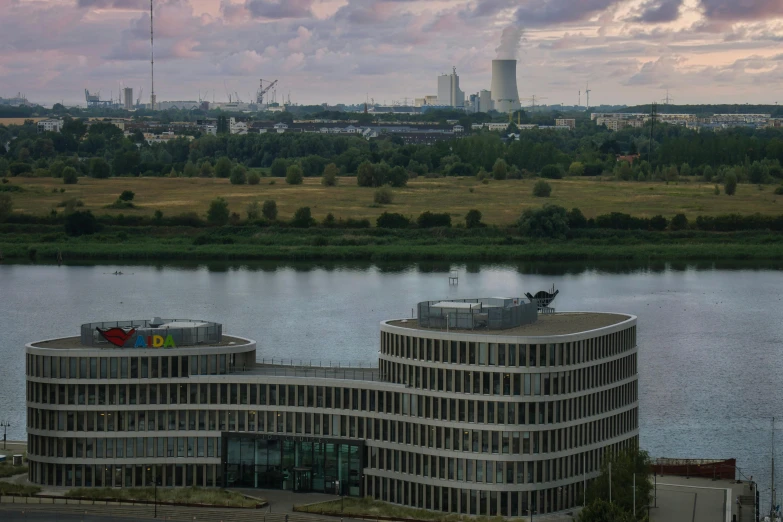 there is a modern architecture next to the lake