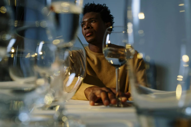 the man sitting at the table is surrounded by empty wine glasses