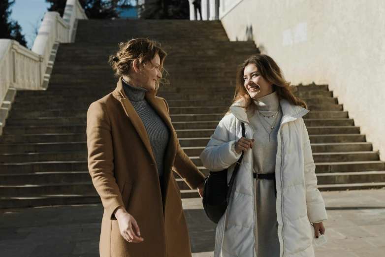 a man and woman walk down the street together