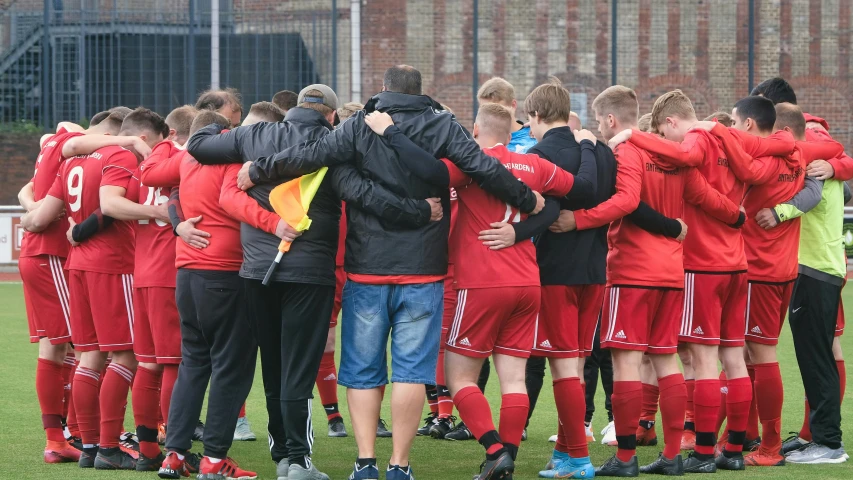 people are huddled together during a soccer game