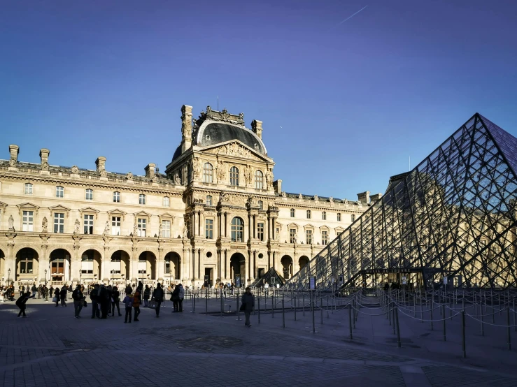 several people walking around a very large and big building