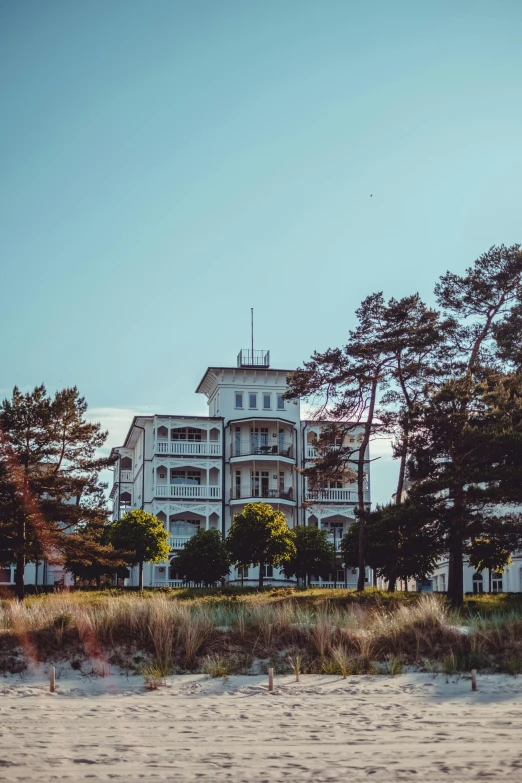 an ocean front house sits next to some trees