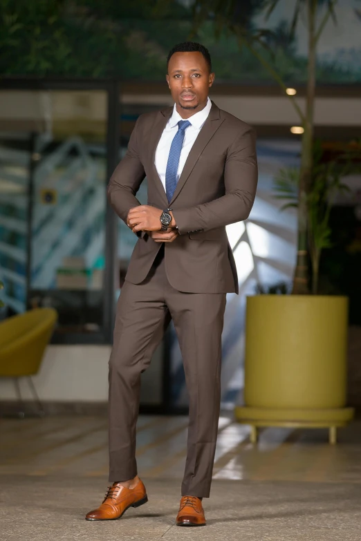 a man standing in a suit and tie in front of a building