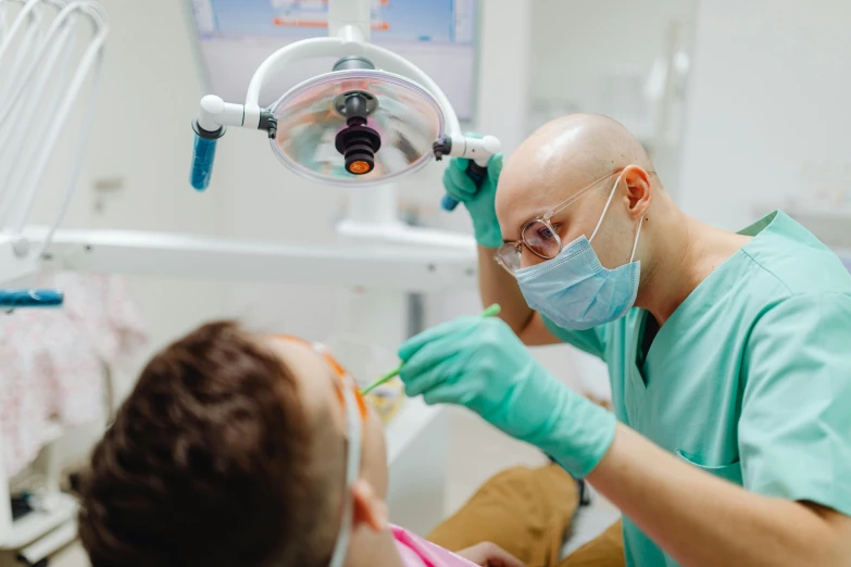 a man getting his teeth checked by a dentist