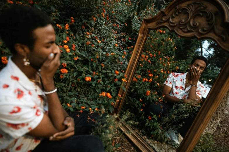 a man is sitting in front of a mirror