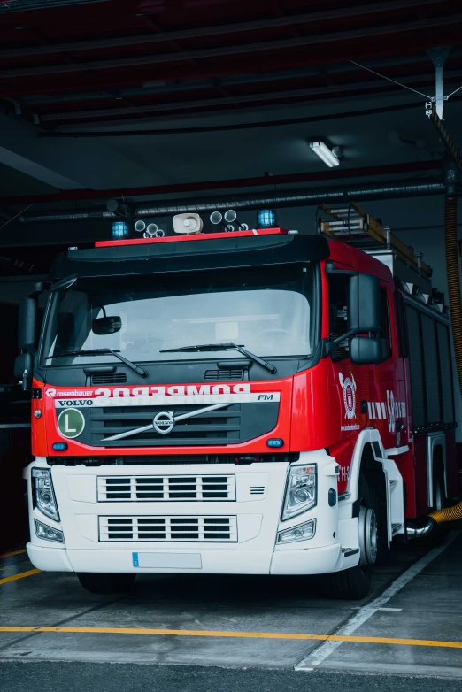 a red truck parked inside of a building