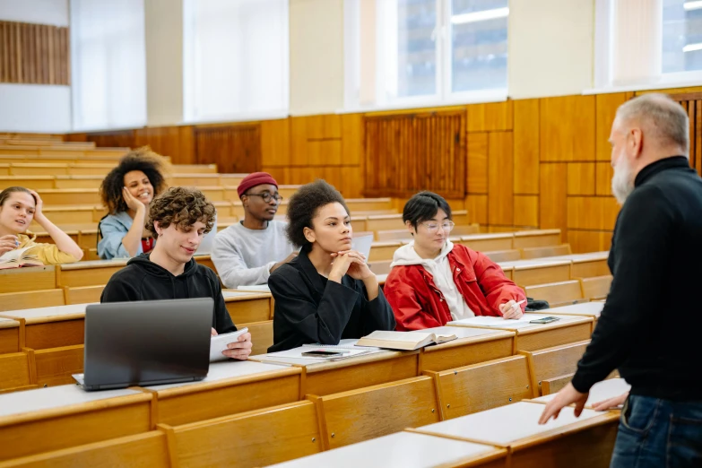 a man is sitting in a lecture hall