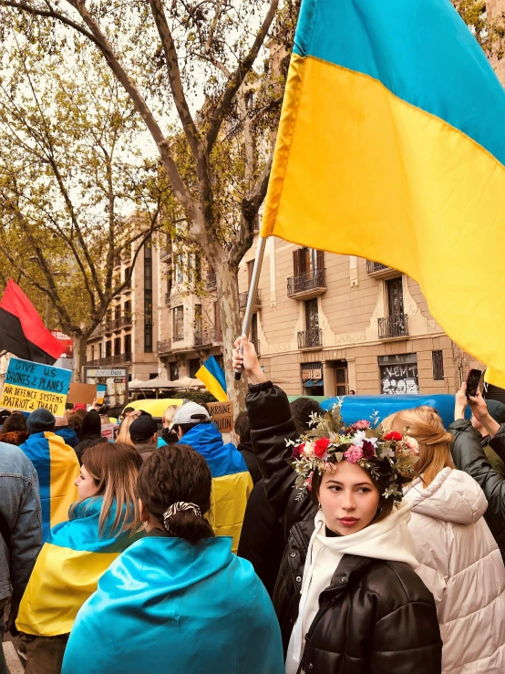 people with flags are gathered in the middle of the street