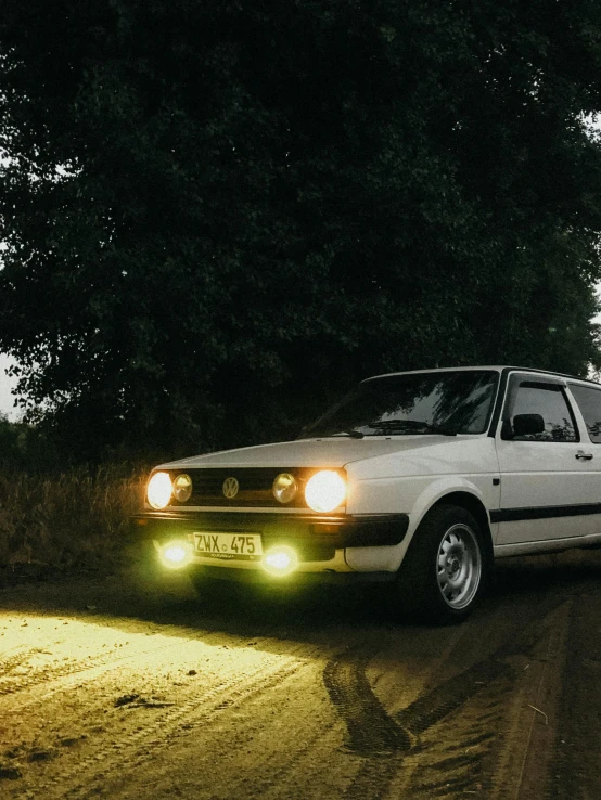 a small car on the side of a road with a light bulb on