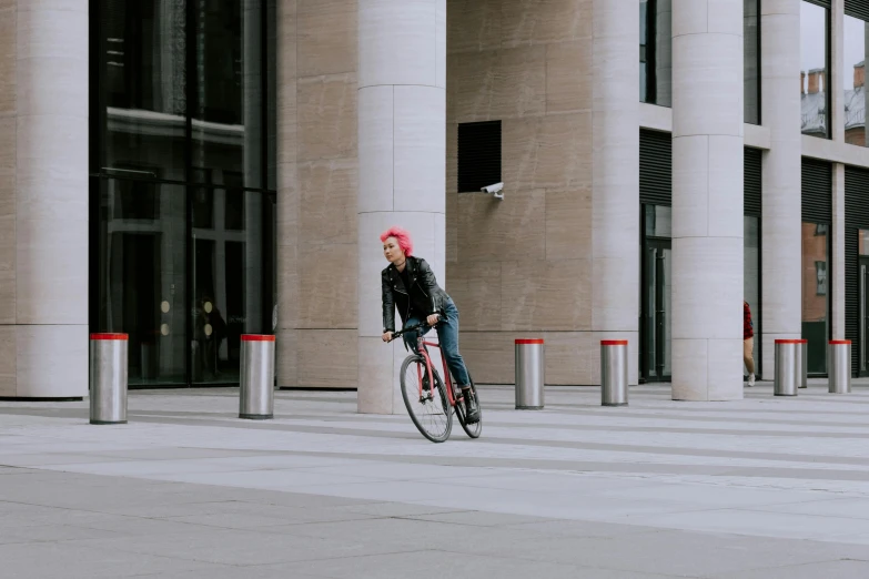 a man with red hair riding a bicycle