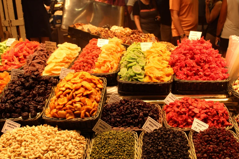 several baskets of various dried nuts and fruit