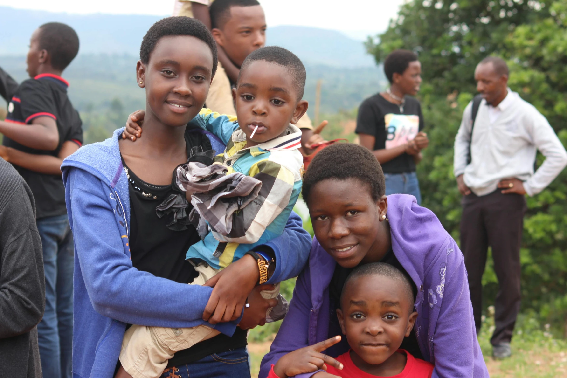 several children standing in front of a group of people