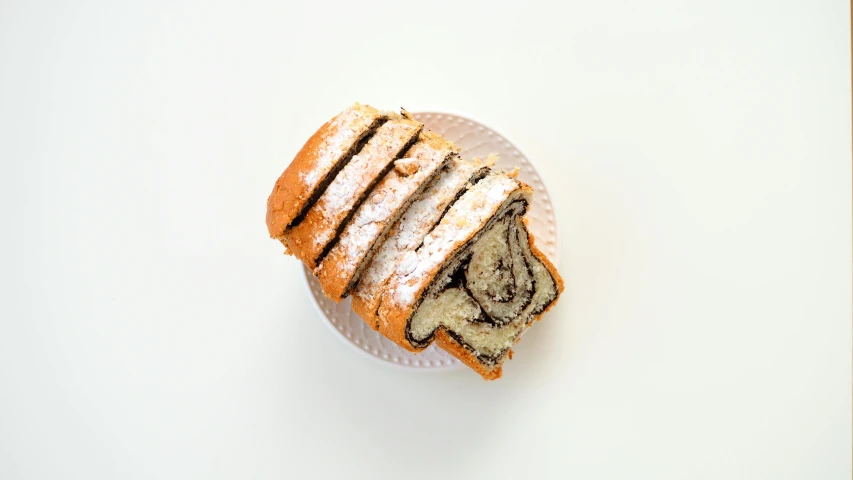 a large piece of sliced cake on a white plate