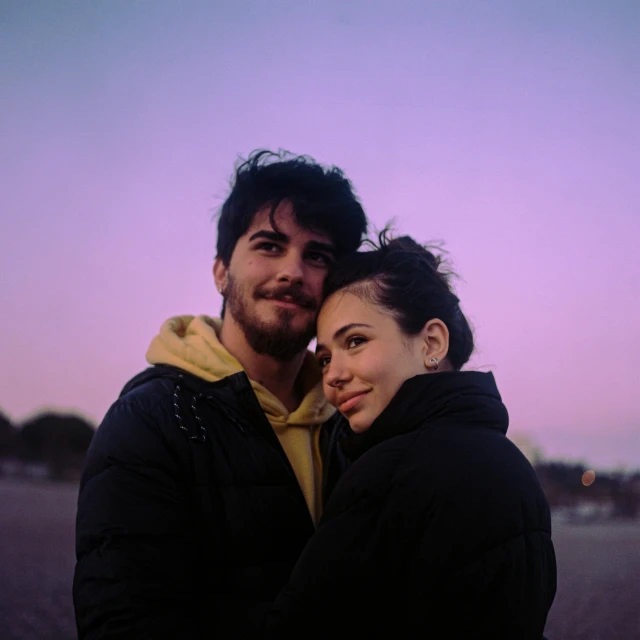 a man and a woman with a city in the background