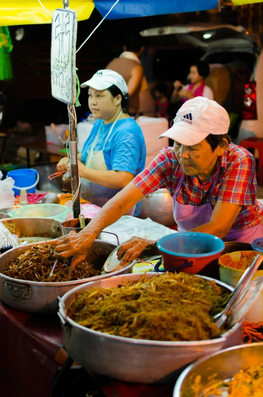 people at an open food market waiting for customers