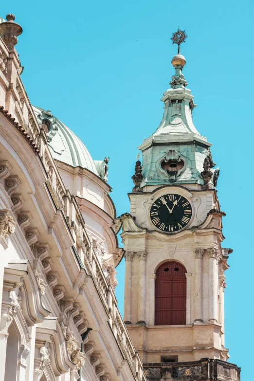 a steeple with a clock at the top and cupola,